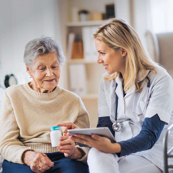 Nurse or carer talking to a older lady