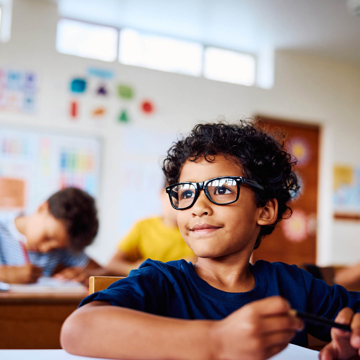 Child with glasses smiling