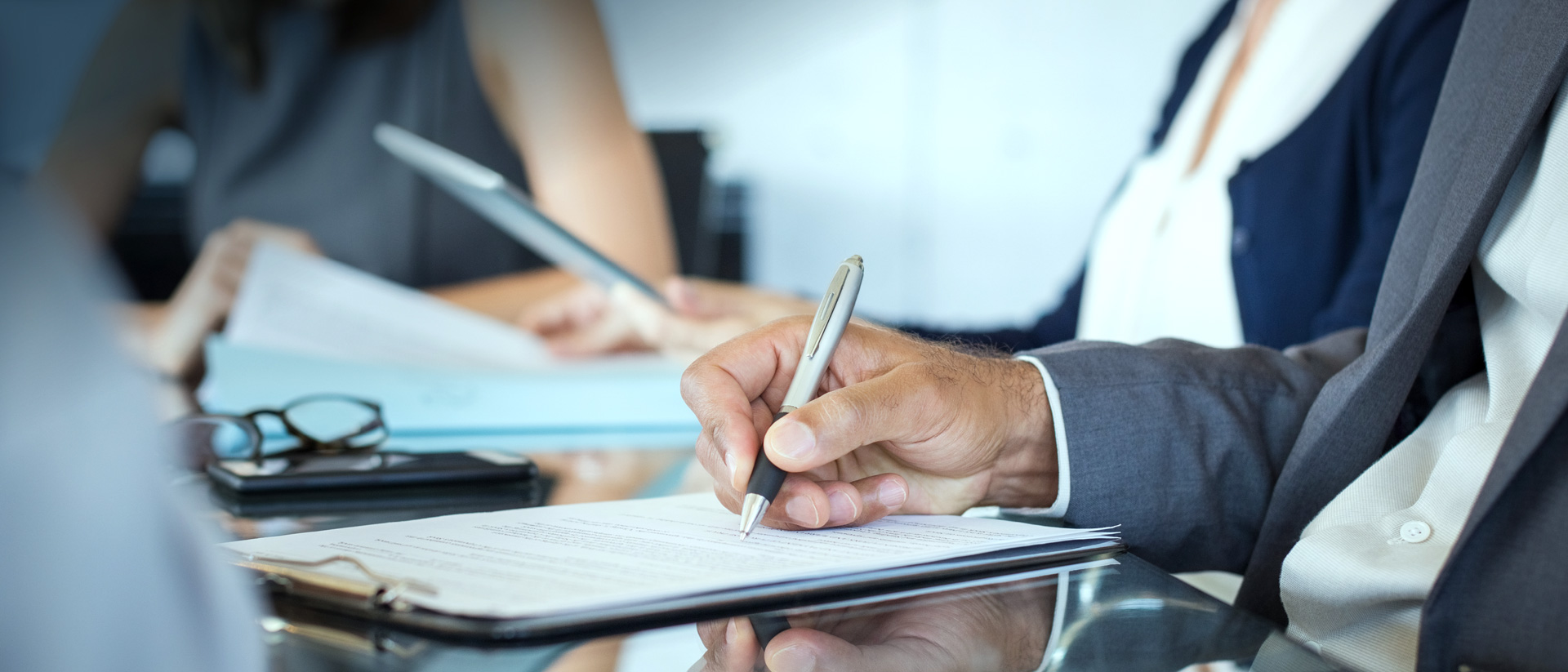 Image of man's hand writing on paper